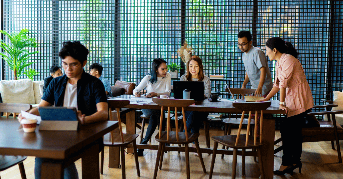 Millennials gathered around in a casual work environment - maslow's hiearchy - millennials - employee engagement
