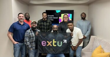 Extu employees pose in new Extu Dallas office