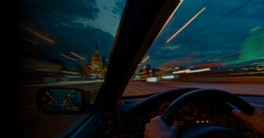 Image of car driving on road with a view of city outside car with motion blur and light trails - B2B Sales Acceleration