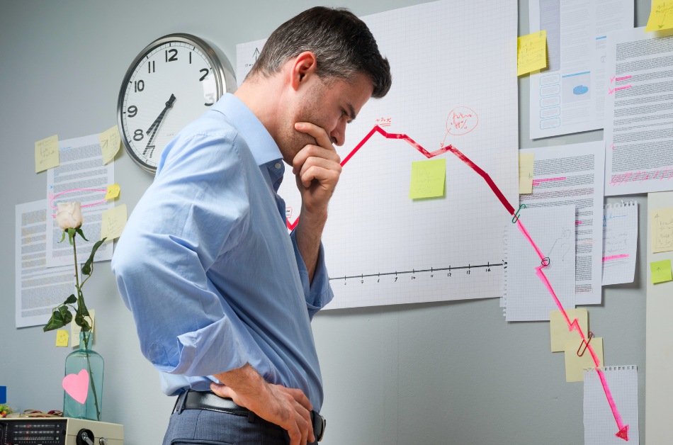 Man looking at chart with downward red arrow - #1 reason channel programs fail