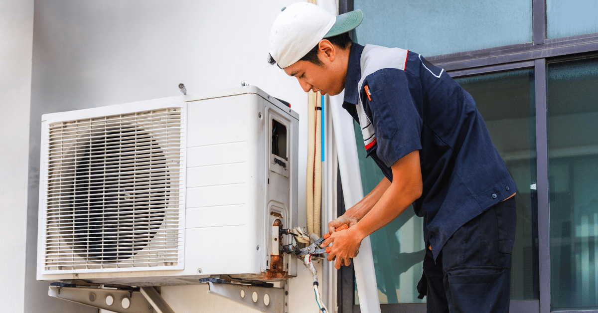 Man working on HVAC unit - How to Strengthen HVAC Dealer Loyalty