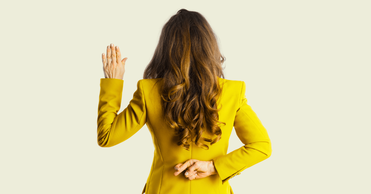 Woman with yellow blazer, raising one hand and the other hand behind her back, fingers crossed - Why Channel Marketing Dashboards Lie
